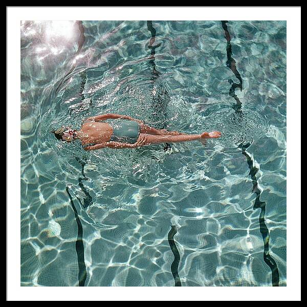 A Woman Swimming In A Pool Framed Print