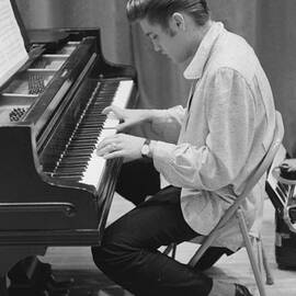 Elvis Presley on piano while waiting for a show to start 1956 by The Harrington Collection