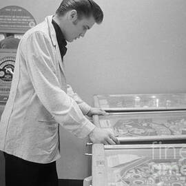 Elvis Presley playing Pinball 1956 by The Harrington Collection