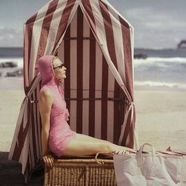 Model In Pink Swimsuit With Tent On Beach by Louise Dahl-Wolfe