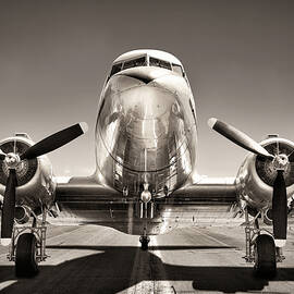 vintage airplane on a runway by Julien
